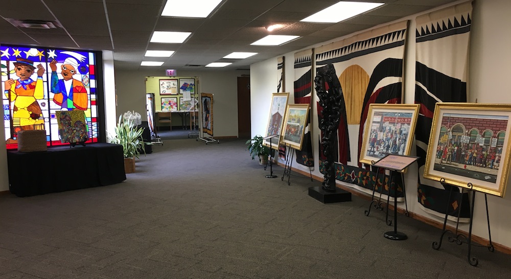 Empty church hall displaying art potraits and pictures around walls