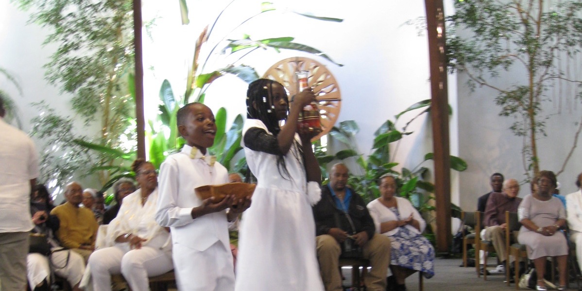 Two children bringing up the bread and wine during Mass