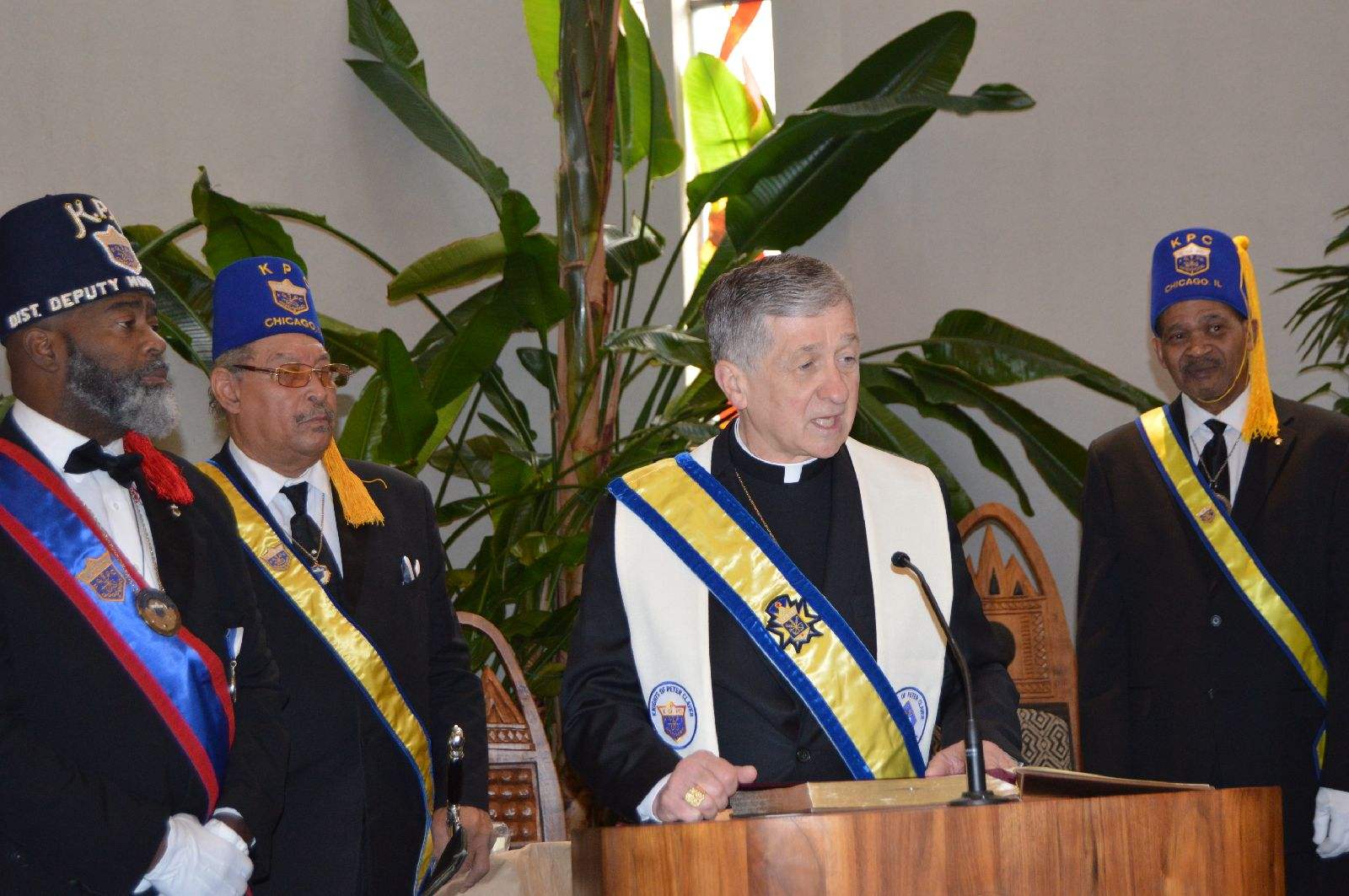 Caridnal Cupich at podium with Knights of Peter Claver