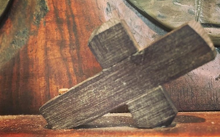 Closeup of wooden Christian cross slanted.
